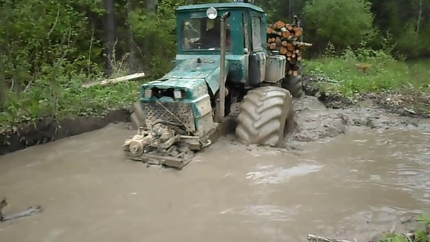 Homemade forwarder logging in wet forest,